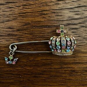 Gold tone safety pin brooch with multicoloured rhinestone crown
